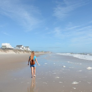 Girl walking on North Topsail Beach | Coastline Realty Topsail Island Beach Rentals
